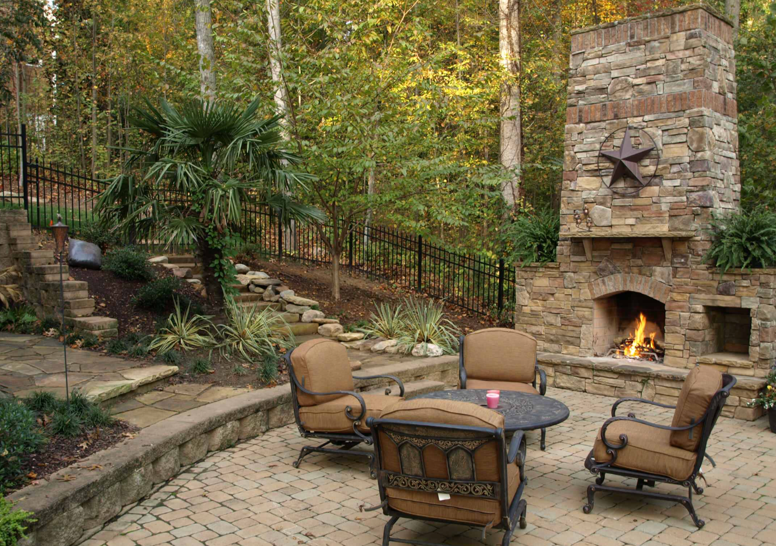 Outdoor stone fireplace with brick patio