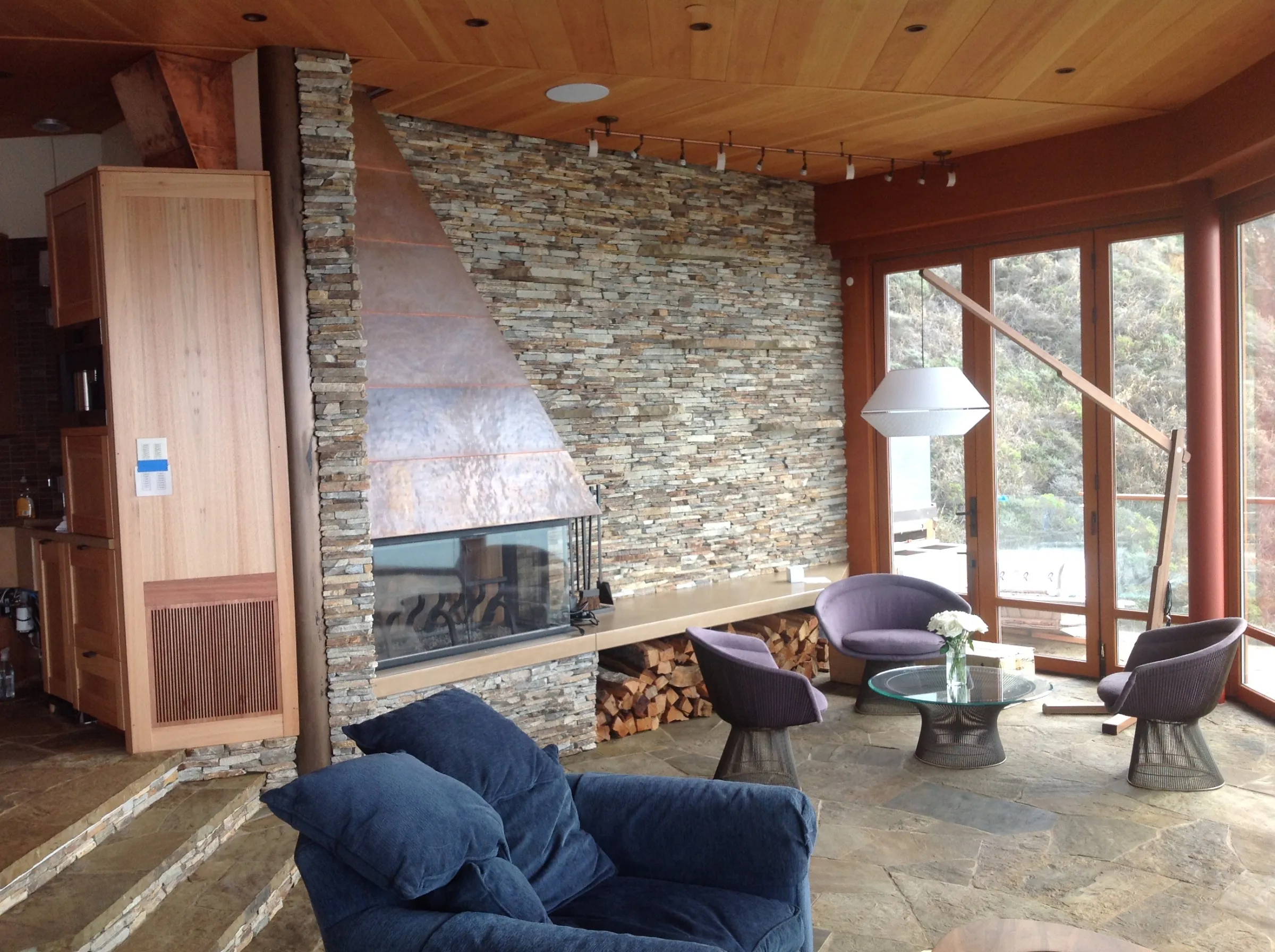 Stacked stone fireplace with copper hood