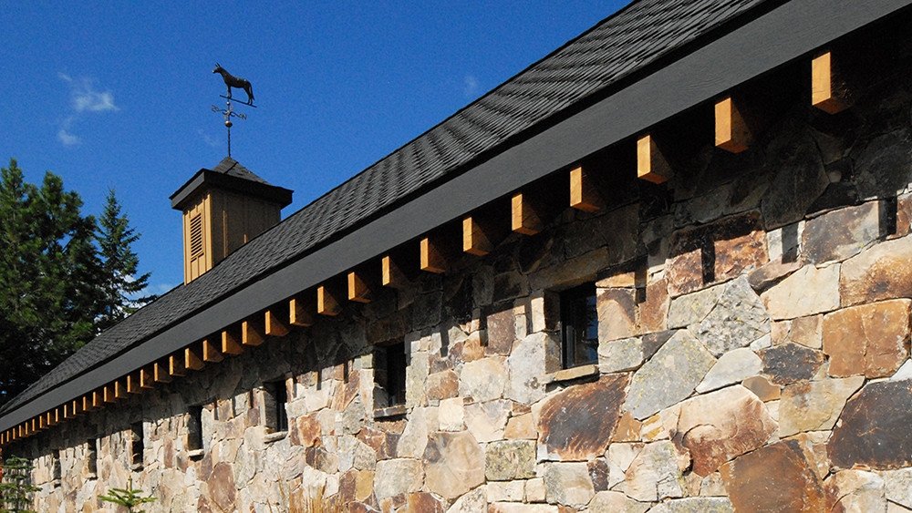 Precision dry stone wall with timber eave detail